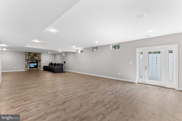 Empty room, Fireplace, Interior, Recessed Lighting, Stone Walls, Wood Texture Flooring