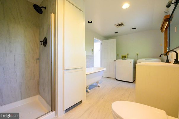 Bathroom, Free Standing Baths, Interior, Recessed Lighting, Washer, Wood Texture Flooring