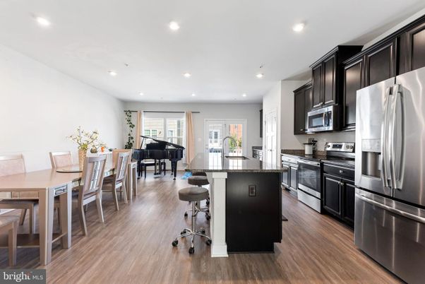 Dining room, Interior, Kitchen, Piano, Recessed Lighting, Stainless Steel Appliances, Wood Texture Flooring