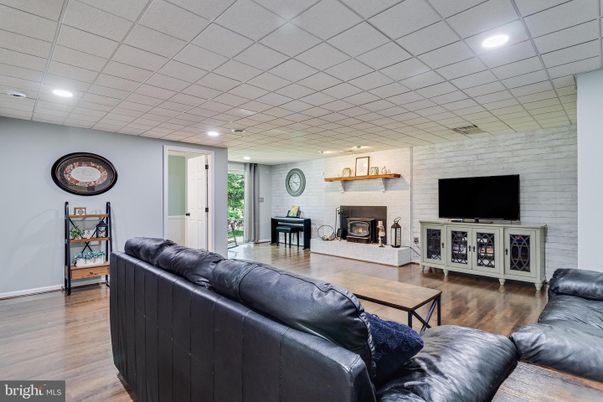 Fireplace, Interior, Living room, Piano, Recessed Lighting, Stone Walls, Wood Texture Flooring