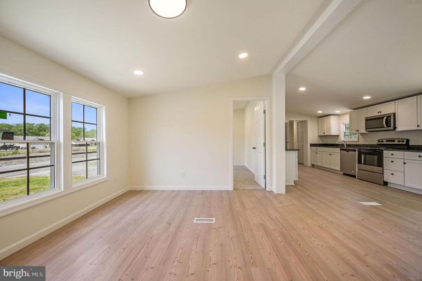 Empty room, Interior, Kitchen, Recessed Lighting, Stainless Steel Appliances, Wood Texture Flooring