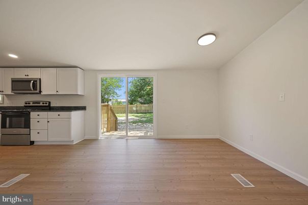 Empty room, Interior, Kitchen, Recessed Lighting, Stainless Steel Appliances, Wood Texture Flooring