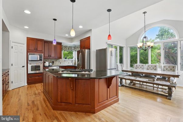 Chandelier, Dining room, Interior, Kitchen, Pendant Lights, Recessed Lighting, Stainless Steel Appliances, Wood Texture Flooring