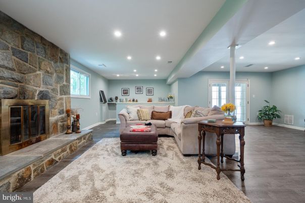 Fireplace, Interior, Living room, Recessed Lighting, Stone Walls, Wood Texture Flooring