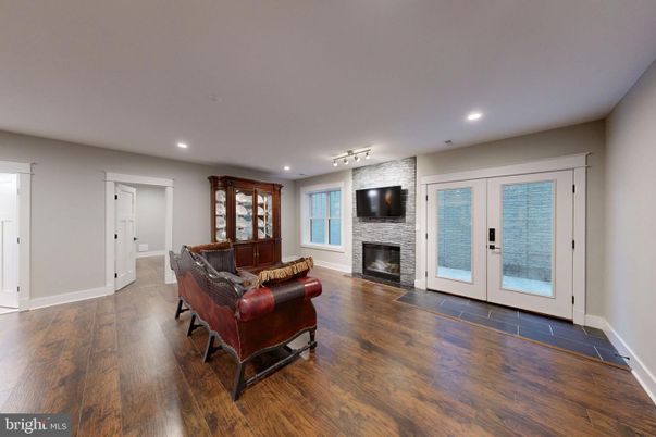 Fireplace, Interior, Living room, Recessed Lighting, Stone Walls, Wood Texture Flooring