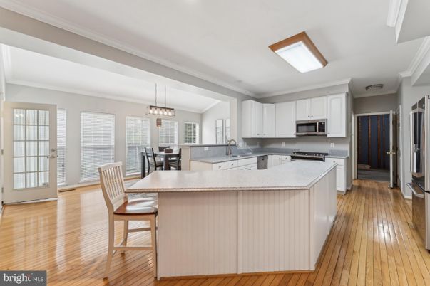 Chandelier, Dining room, Interior, Kitchen, Pendant Lights, Stainless Steel Appliances, Wood Texture Flooring