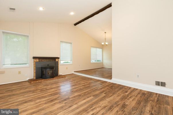 Chandelier, Empty room, Fireplace, Interior, Recessed Lighting, Wooden Beams, Wood Texture Flooring