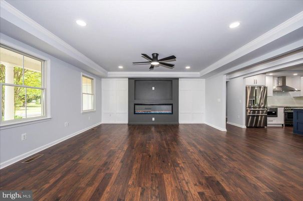 Empty room, Fireplace, Interior, Kitchen, Recessed Lighting, Stainless Steel Appliances, Wood Texture Flooring