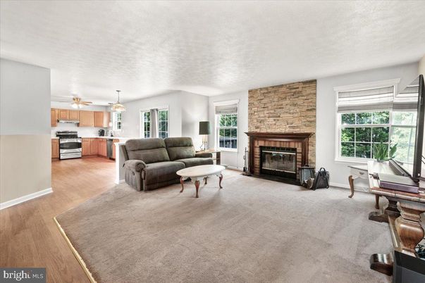 Fireplace, Interior, Kitchen, Living room, Pendant Lights, Stainless Steel Appliances, Stone Walls, Wood Texture Flooring