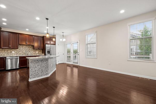 Empty room, Interior, Kitchen, Pendant Lights, Recessed Lighting, Stainless Steel Appliances, Wood Texture Flooring