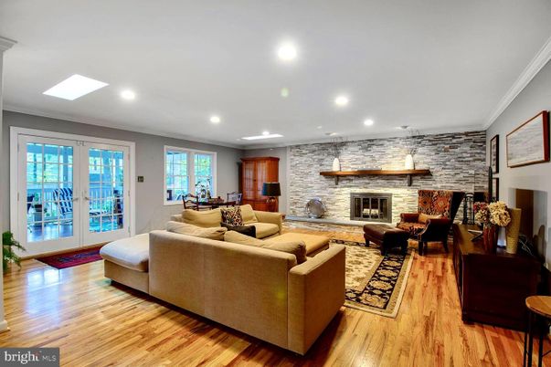 Dining room, Fireplace, Interior, Living room, Recessed Lighting, Stone Walls, Wood Texture Flooring