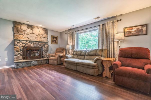 Fireplace, Interior, Living room, Recessed Lighting, Stone Walls, Wood Texture Flooring