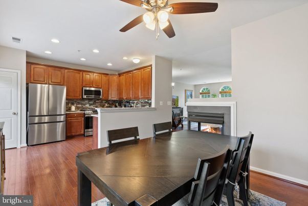 Dining room, Fireplace, Interior, Kitchen, Recessed Lighting, Stainless Steel Appliances, Wood Texture Flooring
