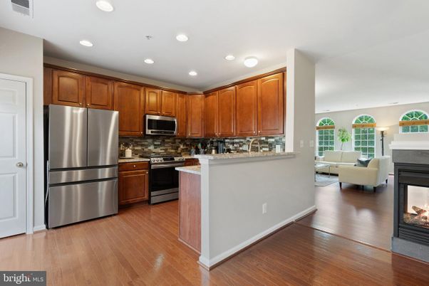 Fireplace, Interior, Kitchen, Living room, Recessed Lighting, Stainless Steel Appliances, Wood Texture Flooring