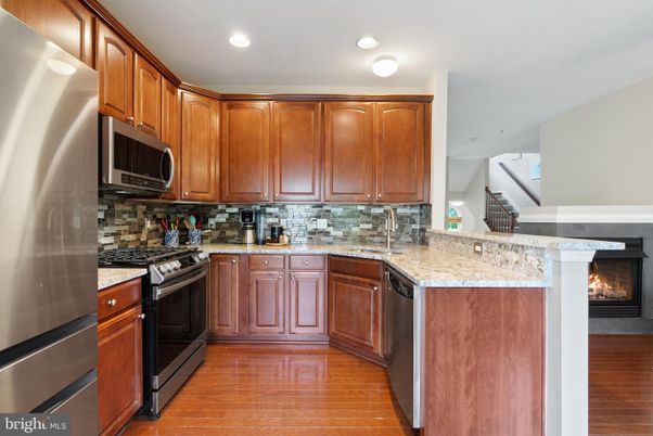 Fireplace, Interior, Kitchen, Recessed Lighting, Stainless Steel Appliances, Wood Texture Flooring