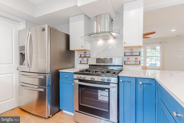 Interior, Kitchen, Marble Walls, Recessed Lighting, Stainless Steel Appliances, Wood Texture Flooring