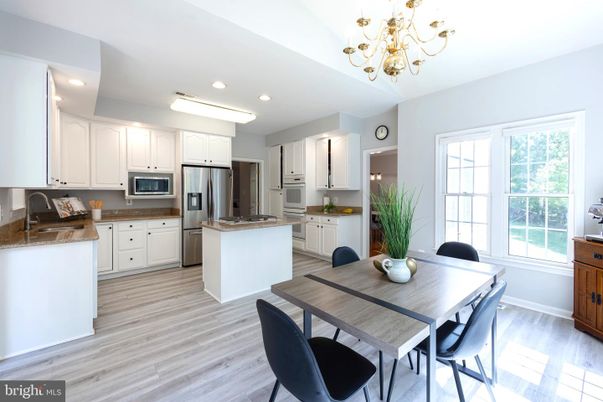 Chandelier, Dining room, Interior, Kitchen, Recessed Lighting, Stainless Steel Appliances, Wood Texture Flooring