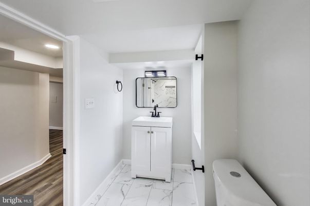 Bathroom, Dual Sink Vanities, Interior, Marble, Recessed Lighting, Wood Texture Flooring