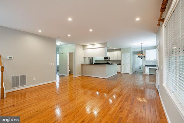 Chandelier, Empty room, Interior, Kitchen, Recessed Lighting, Stainless Steel Appliances, Wood Texture Flooring