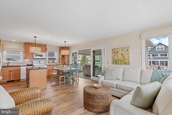 Chandelier, Dining room, Interior, Kitchen, Living room, Pendant Lights, Recessed Lighting, Stainless Steel Appliances, Wood Texture Flooring