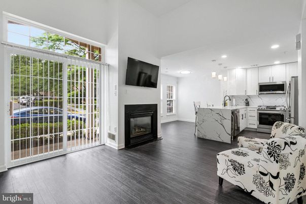 Fireplace, Interior, Kitchen, Marble Walls, Pendant Lights, Recessed Lighting, Stainless Steel Appliances, Wood Texture Flooring