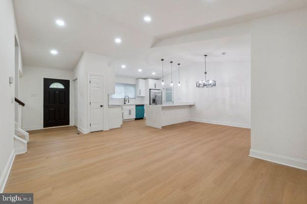 Empty room, Interior, Kitchen, Pendant Lights, Recessed Lighting, Stainless Steel Appliances, Wood Texture Flooring