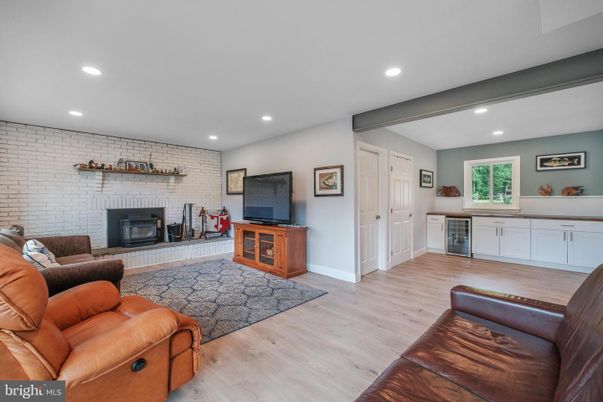 Fireplace, Interior, Living room, Recessed Lighting, Stone Walls, Wood Texture Flooring