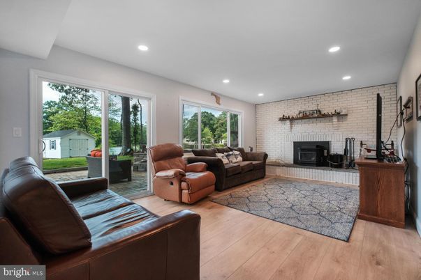 Fireplace, Interior, Living room, Recessed Lighting, Stone Walls, Wood Texture Flooring