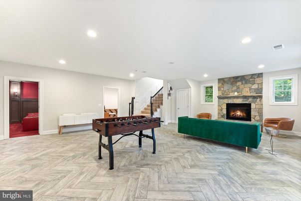 Fireplace, Game Room, Interior, Living room, Recessed Lighting, Stone Walls, Wood Texture Flooring