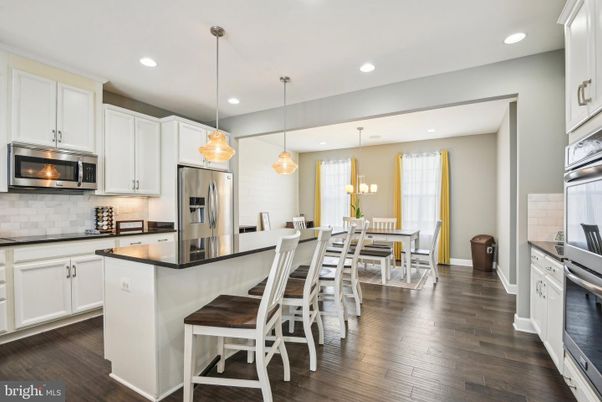 Dining room, Interior, Kitchen, Pendant Lights, Recessed Lighting, Stainless Steel Appliances, Wood Texture Flooring