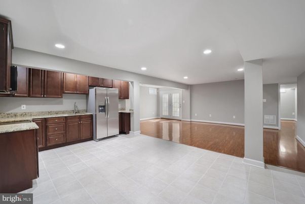 Empty room, Interior, Kitchen, Recessed Lighting, Stainless Steel Appliances, Wood Texture Flooring