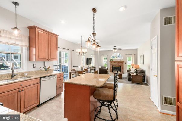 Chandelier, Dining room, Fireplace, Interior, Kitchen, Living room, Pendant Lights, Recessed Lighting, Stainless Steel Appliances