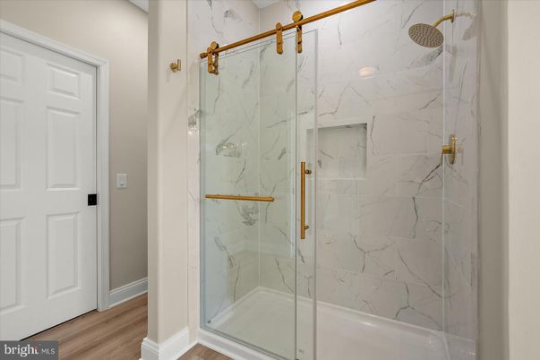 Bathroom, Glass Shower, Interior, Marble Walls, Wood Texture Flooring