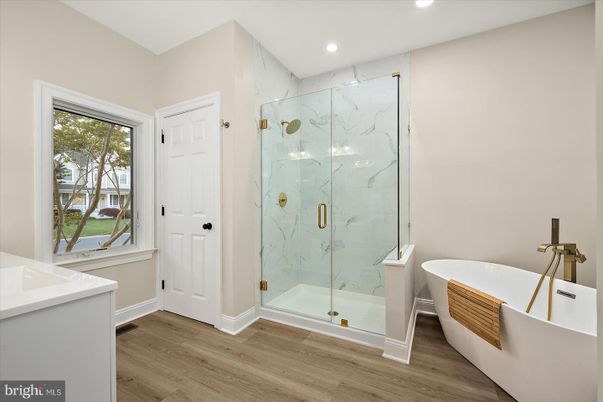 Bathroom, Free Standing Baths, Glass Shower, Interior, Marble Walls, Recessed Lighting, Wood Texture Flooring