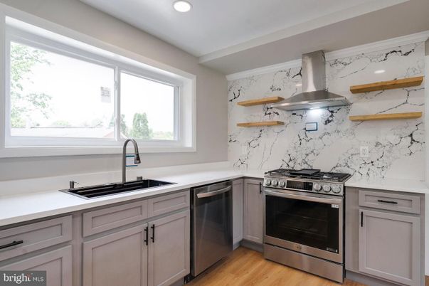 Interior, Kitchen, Marble Walls, Recessed Lighting, Stainless Steel Appliances, Wood Texture Flooring