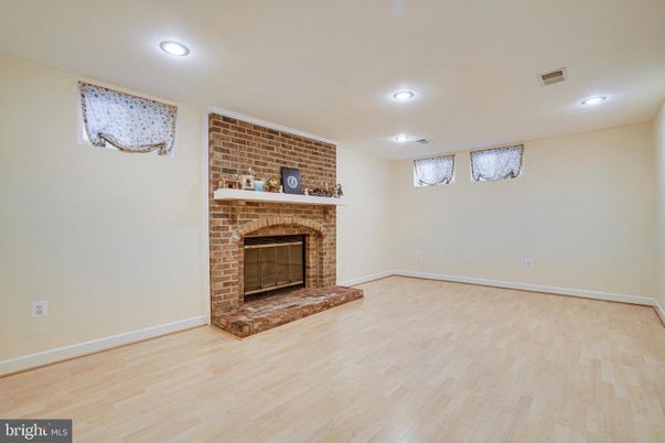 Empty room, Fireplace, Interior, Recessed Lighting, Stone Walls, Wood Texture Flooring