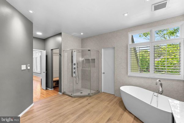 Bathroom, Free Standing Baths, Glass Shower, Interior, Recessed Lighting, Wood Texture Flooring