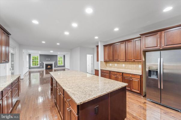 Fireplace, Interior, Kitchen, Recessed Lighting, Stainless Steel Appliances, Wood Texture Flooring