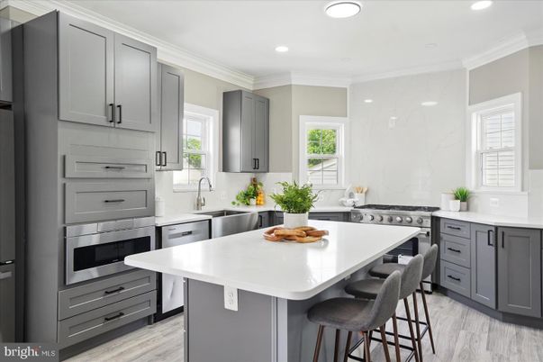 Interior, Kitchen, Marble Walls, Recessed Lighting, Stainless Steel Appliances, Wood Texture Flooring