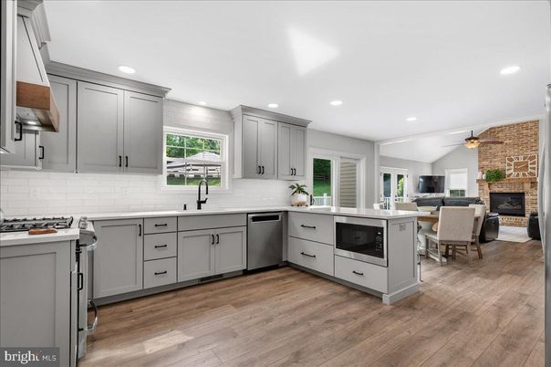 Dining room, Fireplace, Interior, Kitchen, Recessed Lighting, Stainless Steel Appliances, Stone Walls, Wood Texture Flooring