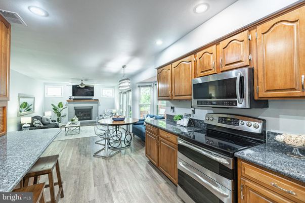 Dining room, Fireplace, Interior, Kitchen, Living room, Pendant Lights, Recessed Lighting, Stainless Steel Appliances, Wood Texture Flooring