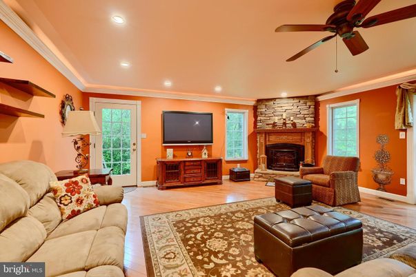 Fireplace, Interior, Living room, Recessed Lighting, Stone Walls, Wood Texture Flooring