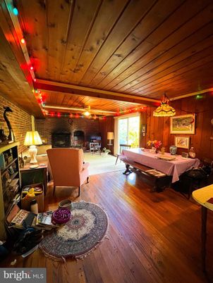 Dining room, Fireplace, Interior, Living room, Pendant Lights, Stone Walls, Wooden Ceilings, Wood Texture Flooring