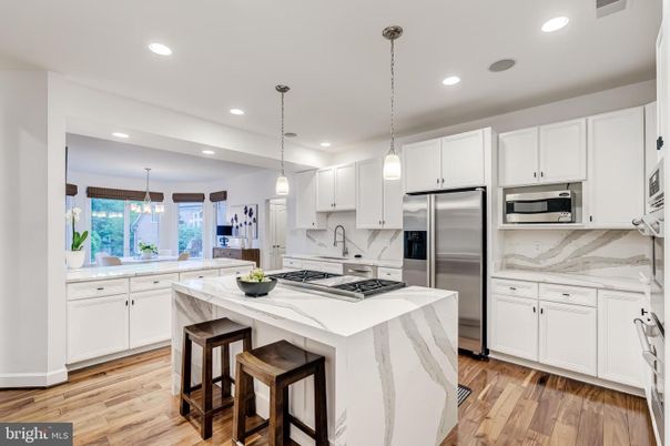 Interior, Kitchen, Marble Walls, Pendant Lights, Recessed Lighting, Stainless Steel Appliances, Wood Texture Flooring