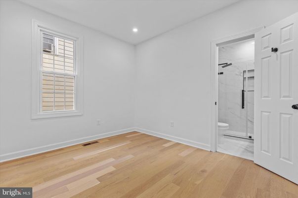 Bathroom, Empty room, Glass Shower, Interior, Marble Walls, Recessed Lighting, Wood Texture Flooring