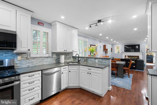 Dining room, Fireplace, Interior, Kitchen, Recessed Lighting, Stainless Steel Appliances, Wood Texture Flooring