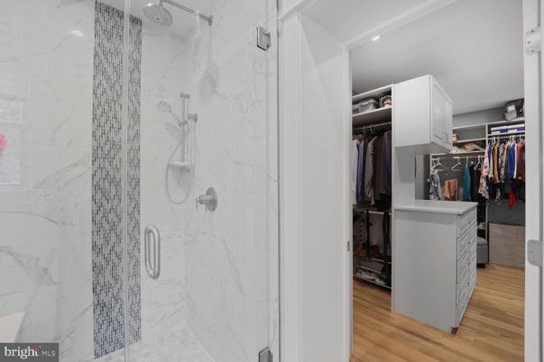 Bathroom, Glass Shower, Interior, Marble Walls, Recessed Lighting, Walk-in Closets, Wood Texture Flooring