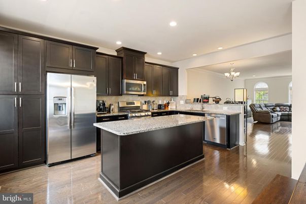 Chandelier, Interior, Kitchen, Living room, Recessed Lighting, Stainless Steel Appliances, Wood Texture Flooring