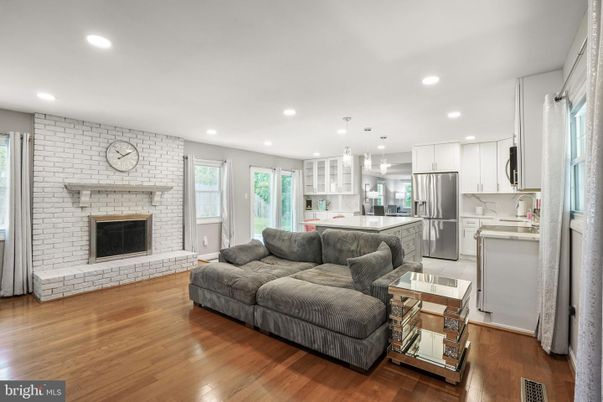 Fireplace, Interior, Kitchen, Living room, Pendant Lights, Recessed Lighting, Stainless Steel Appliances, Stone Walls, Wood Texture Flooring