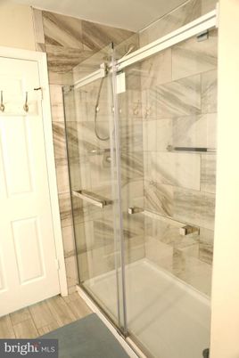 Bathroom, Glass Shower, Interior, Marble Walls, Wood Texture Flooring